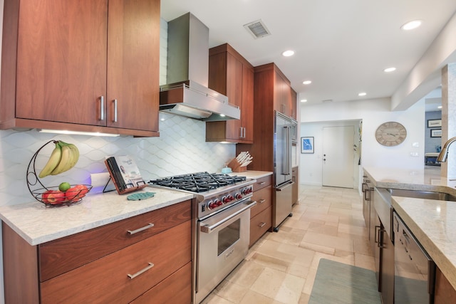 kitchen featuring light stone countertops, custom range hood, sink, backsplash, and high quality appliances