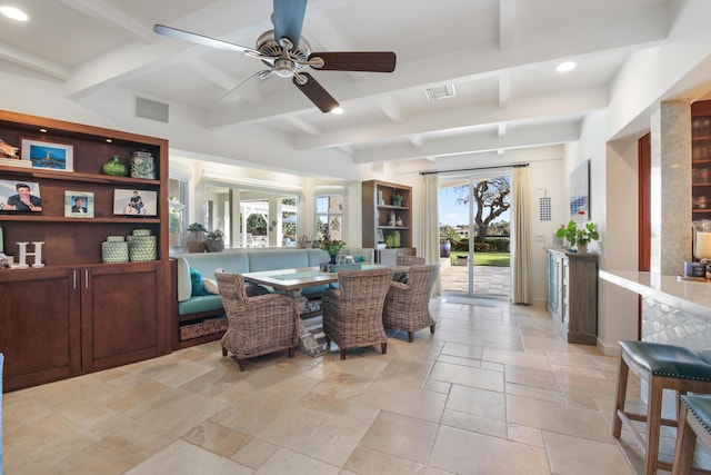 dining space with ceiling fan and beam ceiling