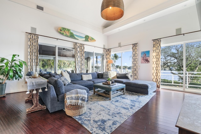 living room with wood-type flooring and a high ceiling