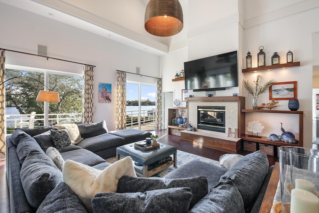 living room with a towering ceiling and wood-type flooring