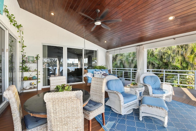 sunroom / solarium featuring ceiling fan, vaulted ceiling, and wooden ceiling