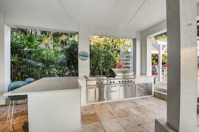 view of patio / terrace featuring area for grilling, exterior kitchen, and exterior bar