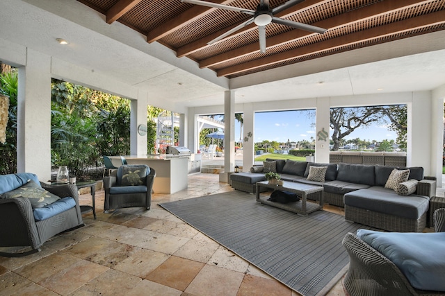 sunroom / solarium featuring beam ceiling