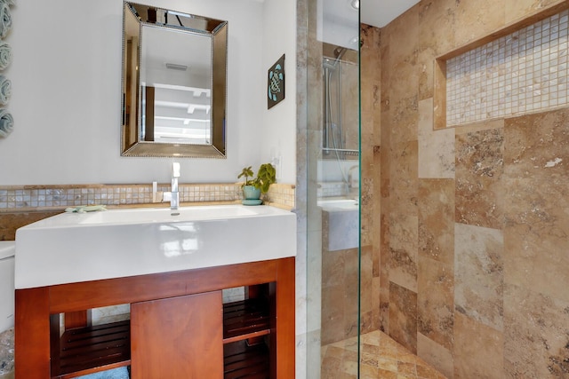 bathroom with vanity, tile walls, and a tile shower