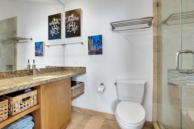 bathroom featuring tile patterned floors, toilet, walk in shower, and vanity