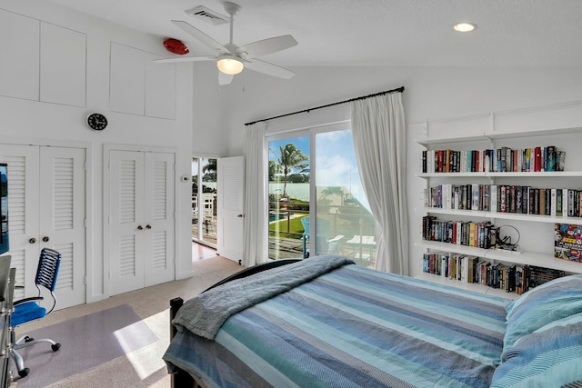 bedroom featuring multiple closets, light carpet, access to outside, ceiling fan, and lofted ceiling