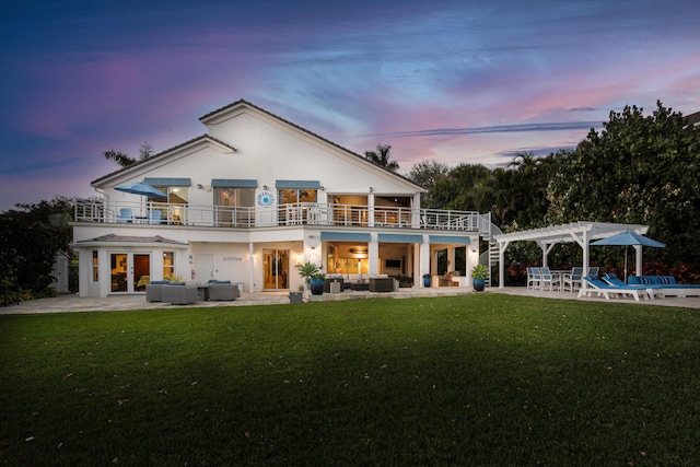 back house at dusk with a pergola, a patio, cooling unit, and outdoor lounge area