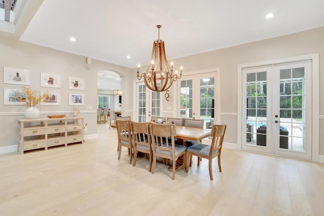 dining area featuring a wealth of natural light, light hardwood / wood-style flooring, and french doors