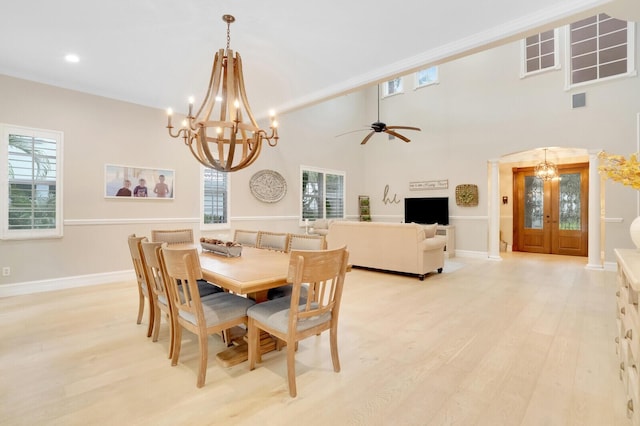 dining area featuring ceiling fan with notable chandelier and light hardwood / wood-style flooring