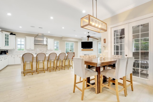 dining space with crown molding, ceiling fan, a wealth of natural light, and french doors