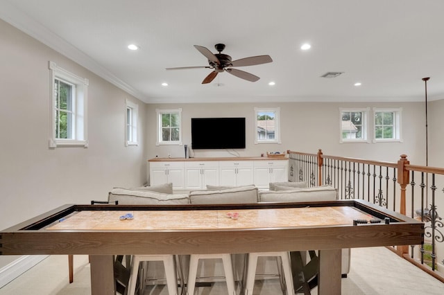 rec room featuring ceiling fan and crown molding