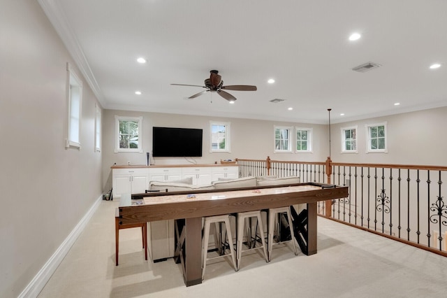 recreation room featuring crown molding and ceiling fan