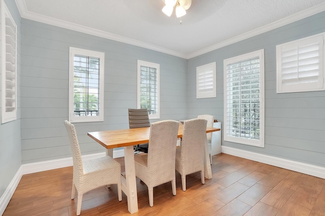 dining room featuring ceiling fan, ornamental molding, and wood-type flooring