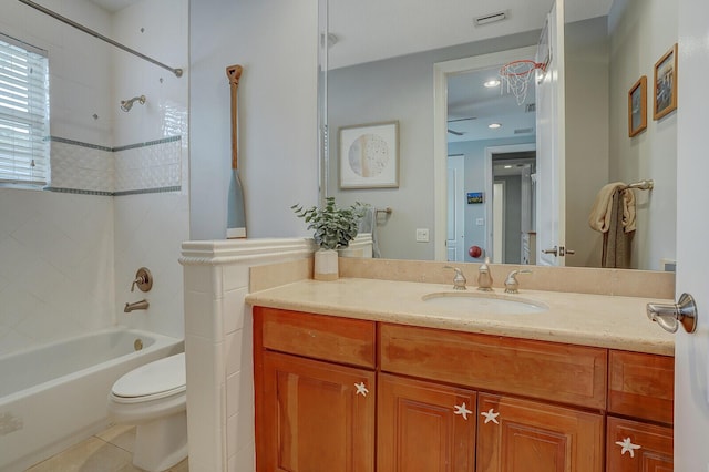 full bathroom featuring tile patterned floors, toilet, vanity, and tiled shower / bath