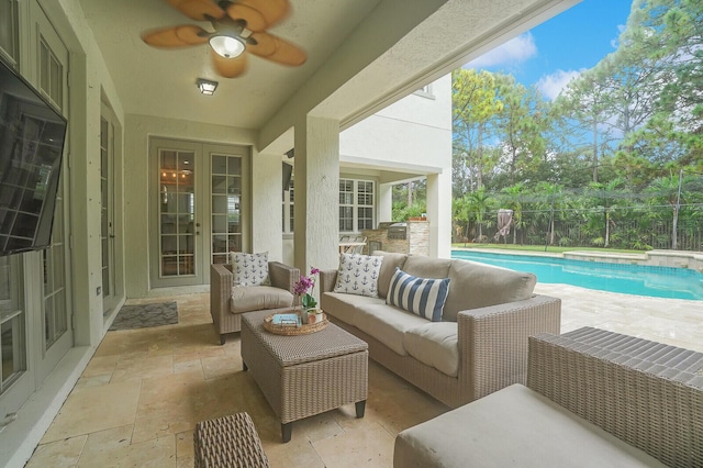 sunroom / solarium featuring ceiling fan and french doors