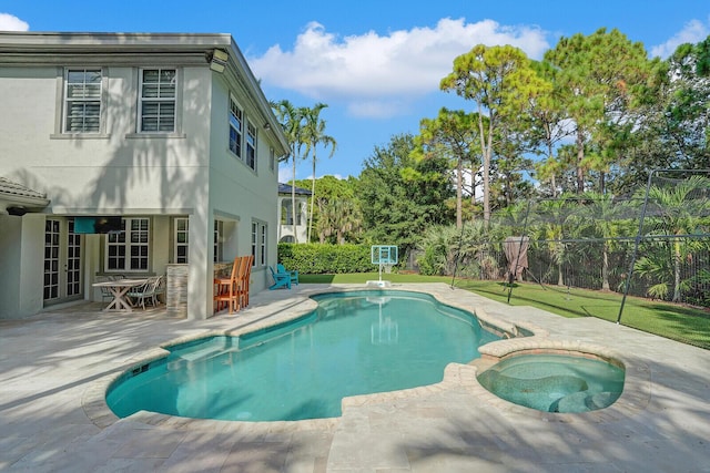 view of pool featuring an in ground hot tub and a patio area