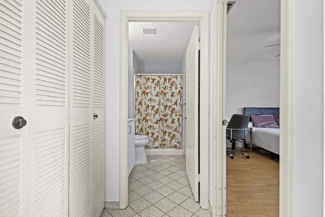 hallway with light hardwood / wood-style floors