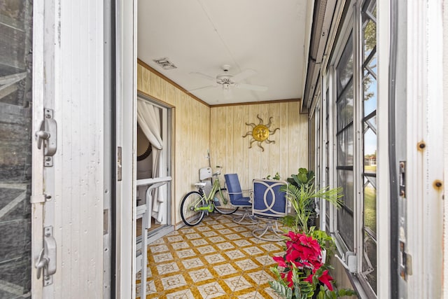 sunroom featuring ceiling fan