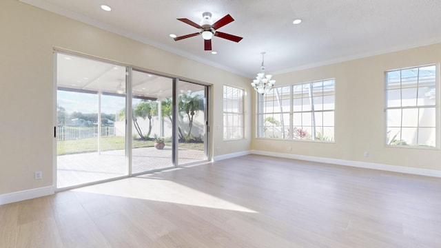 spare room featuring plenty of natural light, ornamental molding, and light wood-type flooring