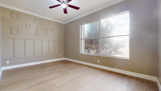 empty room with crown molding, light hardwood / wood-style floors, and ceiling fan