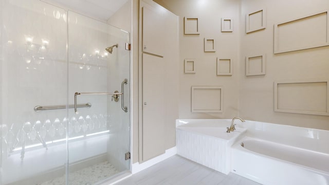 bathroom featuring shower with separate bathtub