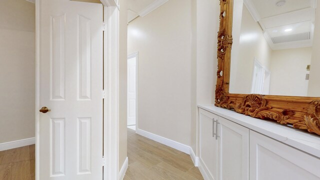 bathroom with vanity, crown molding, and hardwood / wood-style flooring