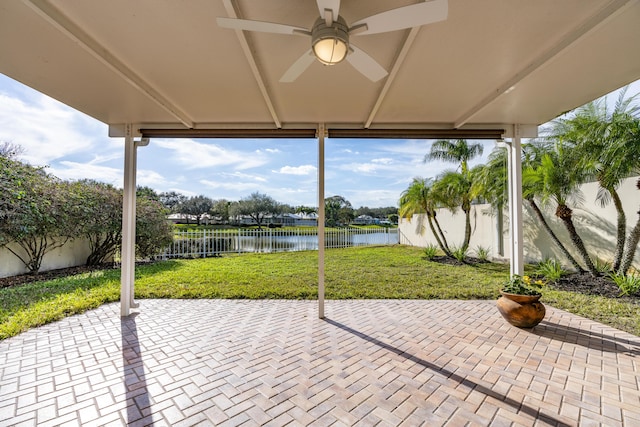 view of patio featuring ceiling fan and a water view