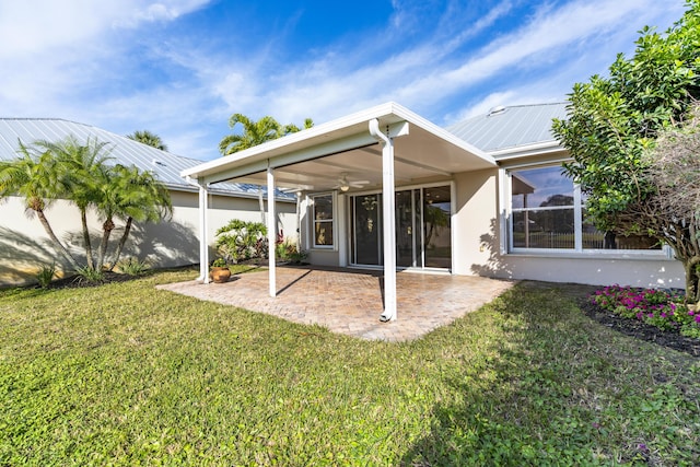 back of property with a patio area, ceiling fan, and a lawn