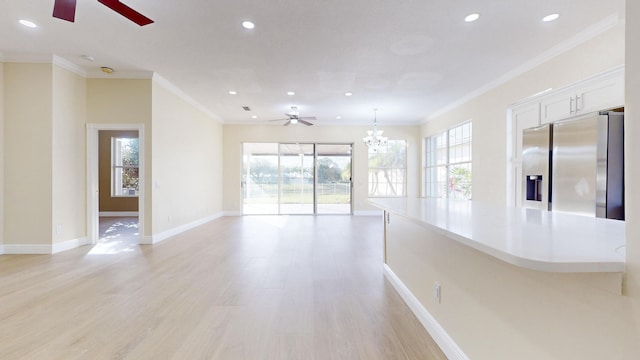 interior space featuring ornamental molding, light hardwood / wood-style floors, and ceiling fan with notable chandelier