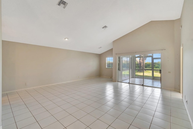 tiled spare room with high vaulted ceiling