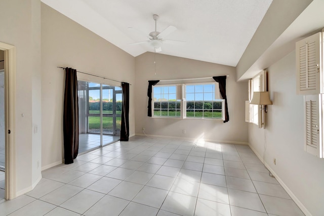 spare room with lofted ceiling, plenty of natural light, and light tile patterned floors