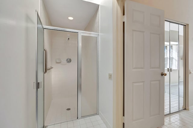 bathroom featuring an enclosed shower and tile patterned flooring