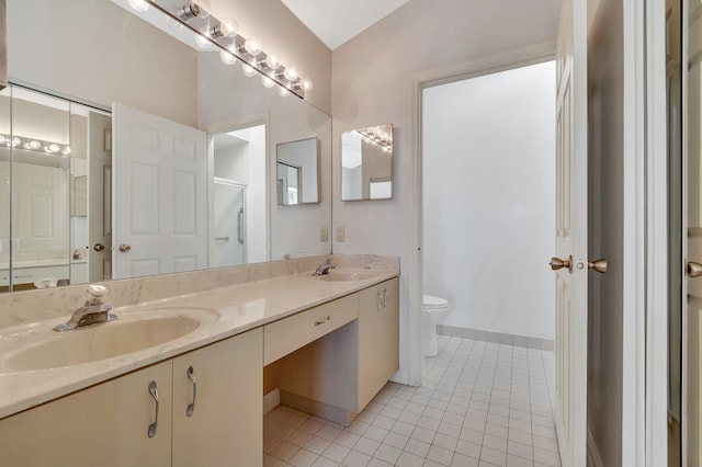 bathroom featuring tile patterned floors, toilet, and vanity