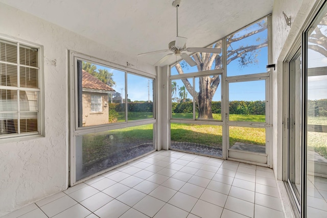 unfurnished sunroom featuring a healthy amount of sunlight and ceiling fan