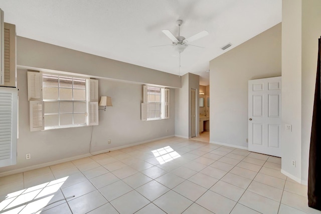 tiled spare room featuring lofted ceiling and ceiling fan