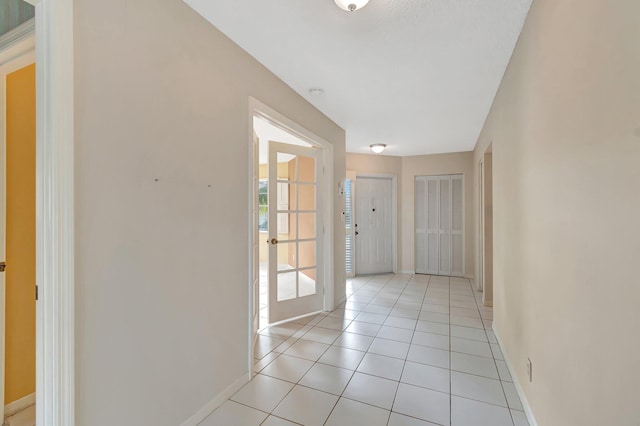 hall with light tile patterned flooring