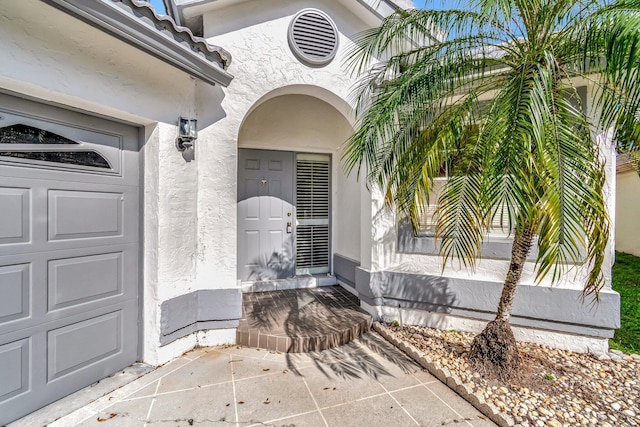 doorway to property with a garage