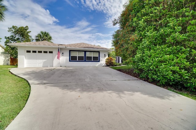 ranch-style house with a garage, driveway, a front yard, and stucco siding