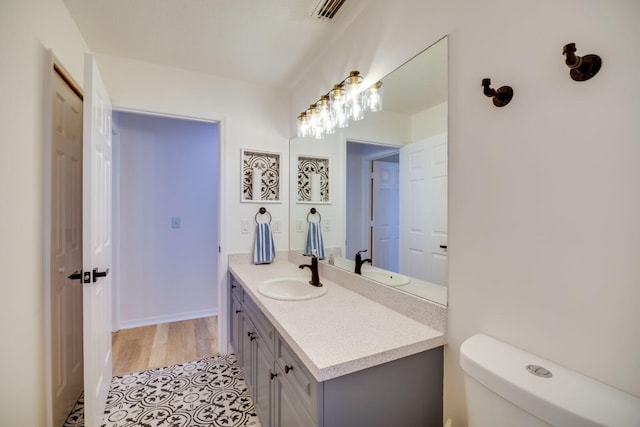 bathroom featuring visible vents, vanity, and toilet