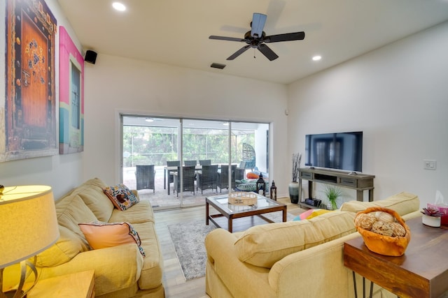 living room with light wood-style floors, visible vents, a ceiling fan, and recessed lighting