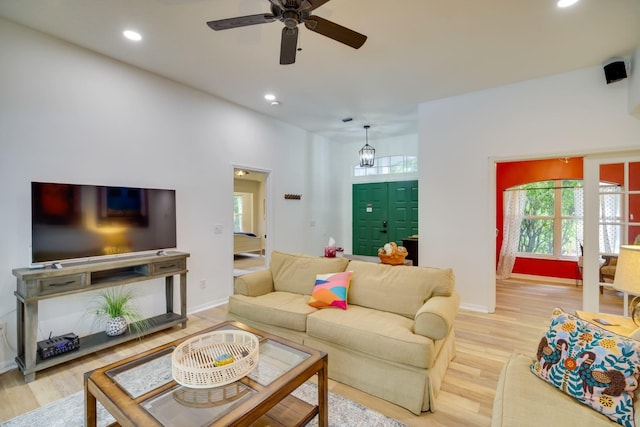 living area with recessed lighting, ceiling fan, baseboards, and wood finished floors