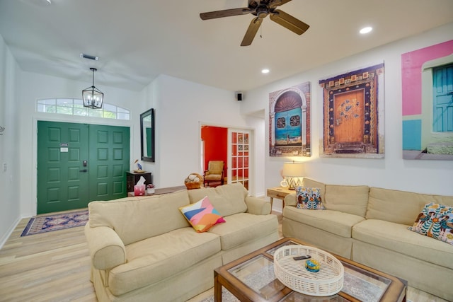 living area featuring baseboards, ceiling fan with notable chandelier, wood finished floors, and recessed lighting