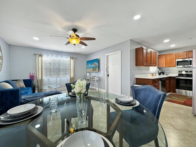 kitchen featuring sink, electric range, and light tile patterned floors