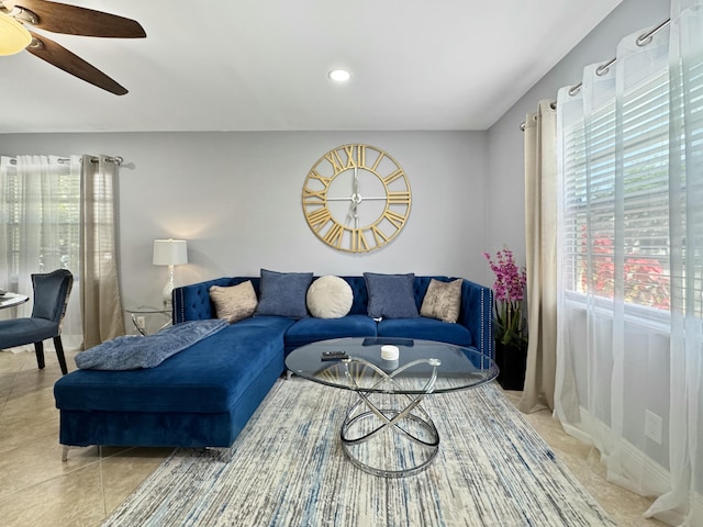 living room with light tile patterned floors and a ceiling fan