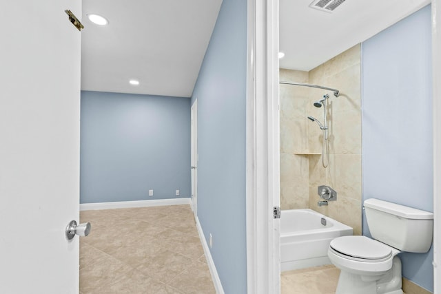 bathroom featuring toilet, tiled shower / bath, and tile patterned flooring