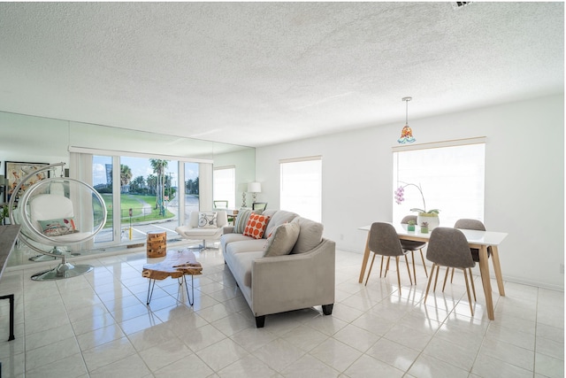 tiled living room featuring a textured ceiling