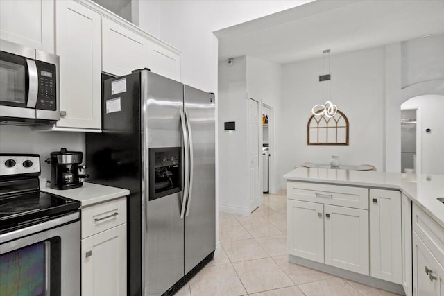 kitchen with white cabinetry, light tile patterned floors, pendant lighting, and appliances with stainless steel finishes