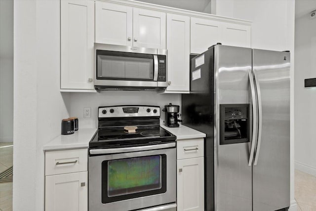 kitchen with white cabinetry and appliances with stainless steel finishes