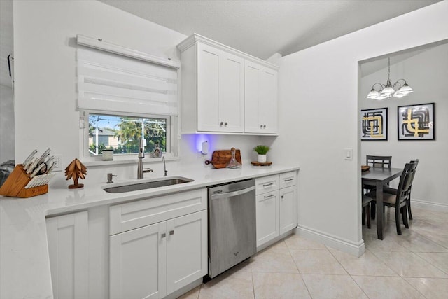 kitchen with light tile patterned flooring, dishwasher, sink, and white cabinets