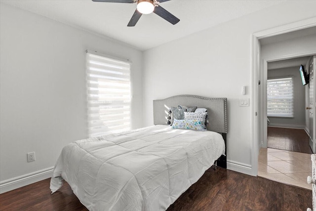 bedroom with ceiling fan and dark hardwood / wood-style flooring